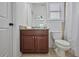 Bathroom with granite countertops, dark wooden vanity, a toilet, and an open window at 336 Valley Brook Ne Way, Atlanta, GA 30342