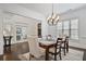 Dining room featuring hardwood floors, a modern chandelier, and access to the foyer at 336 Valley Brook Ne Way, Atlanta, GA 30342