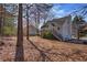 House exterior with a deck nestled in a wooded setting at 145 Bethnal Way, Douglasville, GA 30134