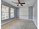 Bedroom features large windows, built in shelving, neutral walls and plush carpet at 247 Bell Grove Ln, Suwanee, GA 30024