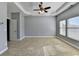 Large bedroom with neutral carpet, tray ceiling, and two windows for plenty of natural light at 247 Bell Grove Ln, Suwanee, GA 30024