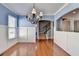 Bright dining area with natural light, hardwood floors, and traditional chandelier at 247 Bell Grove Ln, Suwanee, GA 30024