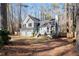 Two-story house with gray siding, three-car garage, and wooded setting at 118 Michael Ct, Dallas, GA 30157