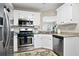 Kitchen boasts stainless steel appliances and white cabinets at 118 Michael Ct, Dallas, GA 30157