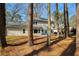 Secluded backyard featuring mature trees and a spacious lawn, perfect for outdoor activities and privacy at 2189 Wood Glen Se Ln, Marietta, GA 30067