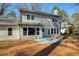 Rear elevation of home and backyard with view of glass doors and blue patio area at 2189 Wood Glen Se Ln, Marietta, GA 30067