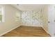 Empty bedroom with a large window, hardwood floors, and floral wallpaper at 2189 Wood Glen Se Ln, Marietta, GA 30067