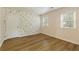 Charming bedroom with hardwood floors, butterfly wallpaper, and natural light from two windows at 2189 Wood Glen Se Ln, Marietta, GA 30067