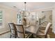 Bright dining room featuring hardwood floors, large windows, and a modern light fixture at 2189 Wood Glen Se Ln, Marietta, GA 30067