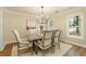 Bright dining room featuring hardwood floors, large windows, and a stylish light fixture at 2189 Wood Glen Se Ln, Marietta, GA 30067