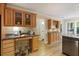 An eat-in kitchen with desk space features granite counters, natural wood cabinets, and views to a hall and dining area at 2189 Wood Glen Se Ln, Marietta, GA 30067