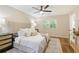 Well-lit main bedroom features neutral paint, a ceiling fan, and an area rug at 2189 Wood Glen Se Ln, Marietta, GA 30067