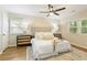 Well-lit main bedroom features neutral paint, a ceiling fan, and an area rug at 2189 Wood Glen Se Ln, Marietta, GA 30067