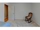 Simple bedroom with carpet floors and a rocking chair at 4065 Delamar Dr, Cumming, GA 30041