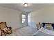 Spacious bedroom with a rocking chair and natural light at 4065 Delamar Dr, Cumming, GA 30041