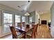 Sunlit dining room with hardwood floors, a wood dining table, and access to the backyard at 4065 Delamar Dr, Cumming, GA 30041