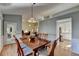 Bright dining room features hardwood floors, a wood table, and large windows at 4065 Delamar Dr, Cumming, GA 30041