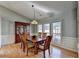 Spacious dining room with hardwood floors, large windows, and a beautiful china cabinet at 4065 Delamar Dr, Cumming, GA 30041