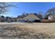 House exterior showcasing a two-car garage and spacious backyard at 4065 Delamar Dr, Cumming, GA 30041