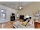 Living room with fireplace, hardwood floors, and access to sunroom at 4065 Delamar Dr, Cumming, GA 30041