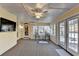 Bright sunroom features carpet flooring, ceiling fan, and French doors leading to the backyard at 4065 Delamar Dr, Cumming, GA 30041