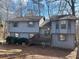 Two-story house with gray siding, wood deck, and mature trees at 4551 Jackybell Trl, Decatur, GA 30034