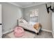 Cozy bedroom with window, plush rug, and wall-mounted TV at 728 Harmony Rd, Temple, GA 30179