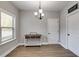 Simple dining room with wood floors and a three-light chandelier at 728 Harmony Rd, Temple, GA 30179