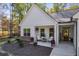 White farmhouse exterior with stone accents, two-car garage, and landscaped yard at 728 Harmony Rd, Temple, GA 30179