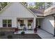 White farmhouse exterior with stone accents, two-car garage, and landscaped yard at 728 Harmony Rd, Temple, GA 30179