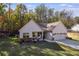 White farmhouse exterior with stone accents, two-car garage, and landscaped yard at 728 Harmony Rd, Temple, GA 30179