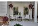 Front porch with seating area and hanging plants at 728 Harmony Rd, Temple, GA 30179