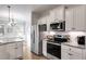 Modern kitchen with stainless steel appliances and granite countertops at 728 Harmony Rd, Temple, GA 30179