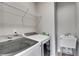 Laundry room with washer, dryer, utility sink and shelving at 728 Harmony Rd, Temple, GA 30179