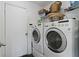 Laundry room with washer and dryer, and overhead shelving at 1653 Village Place Cir, Conyers, GA 30012