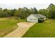 Aerial front view of the home featuring a 2 car garage and long driveway at 3119 E Fairview Rd, Mcdonough, GA 30252