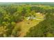 Aerial front view of the home featuring a 2 car garage and long driveway at 3119 E Fairview Rd, Mcdonough, GA 30252