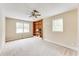 Bright bedroom with a ceiling fan, built-in shelves, and two windows at 3119 E Fairview Rd, Mcdonough, GA 30252