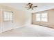 Bedroom with a ceiling fan, a window, and a door to the outside at 3119 E Fairview Rd, Mcdonough, GA 30252