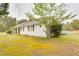 Charming single-story home with a white exterior, black shutters, well-maintained lawn, and mature landscaping at 3119 E Fairview Rd, Mcdonough, GA 30252