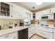Bright kitchen with white cabinets, appliances, and countertop space for food preparation at 3119 E Fairview Rd, Mcdonough, GA 30252