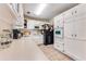 Functional kitchen with white cabinets, black appliances, and ample countertop area at 3119 E Fairview Rd, Mcdonough, GA 30252