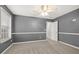 Gray-toned bedroom with a ceiling fan and trim, and a large window offering ample natural light at 3920 Village Estates Ct, Cumming, GA 30040