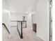 Bright hallway with neutral carpet, white trim and railings, and several doors, creating an airy, spacious feel at 3920 Village Estates Ct, Cumming, GA 30040