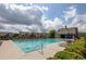 Community pool with inviting blue water and lounge chairs, surrounded by lush greenery on a sunny day at 3920 Village Estates Ct, Cumming, GA 30040