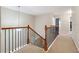 Upstairs hall with staircase and carpet flooring at 4145 Roseman Bridge Ct, Suwanee, GA 30024