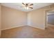 Spacious bedroom with ceiling fan and access to hallway at 6110 Dorsett St, Douglasville, GA 30134