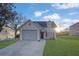 Cute two-story house with a gray garage door and a well-maintained lawn at 6110 Dorsett St, Douglasville, GA 30134