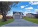 Front view of a house showcasing its gray exterior and a spacious yard at 6110 Dorsett St, Douglasville, GA 30134