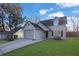 Two-story house with a gray garage door and a green lawn at 6110 Dorsett St, Douglasville, GA 30134